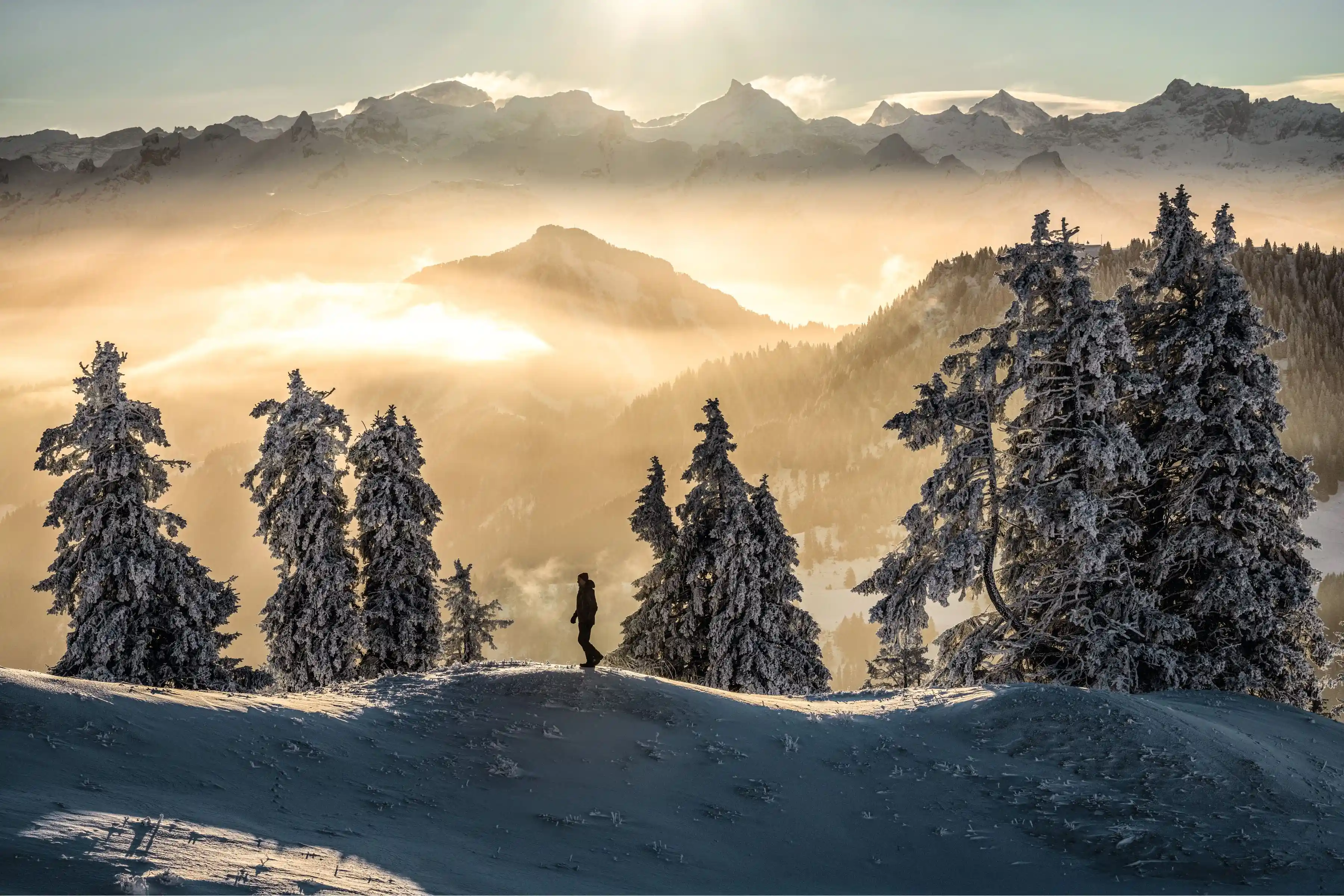 Two hikers hiking through the Rigi Mountain in the winter, it is considered one of the Hidden Gems with Swiss Travel Pass