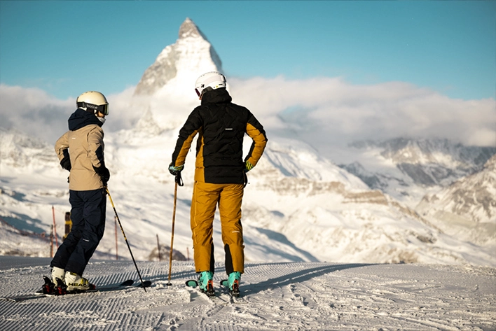 A group of people skiing down a snowy hill in Zermatt, Switzerland.