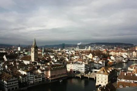 An aerial view of Zurich city, showcasing a mix of historic and modern buildings.